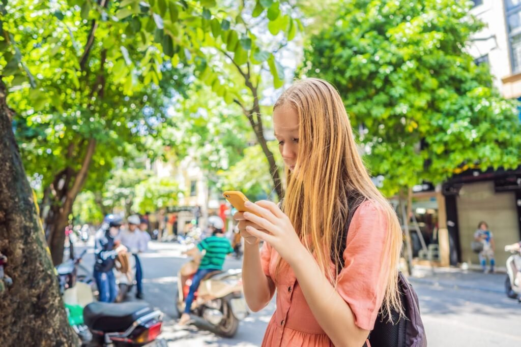 A solo traveler using a travel app on her phone