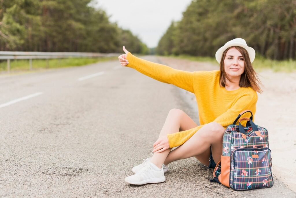 A budget solo traveler resting by the road