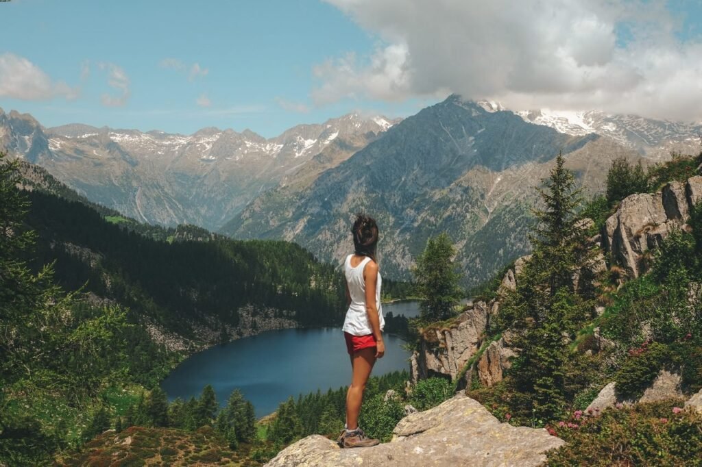 A solo traveler standing on a mountain top, having conquered her fear