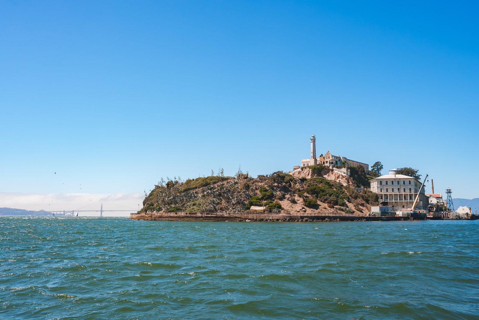 A view of Alcatraz Island with its former prison and lighthouse in San Francisco Bay