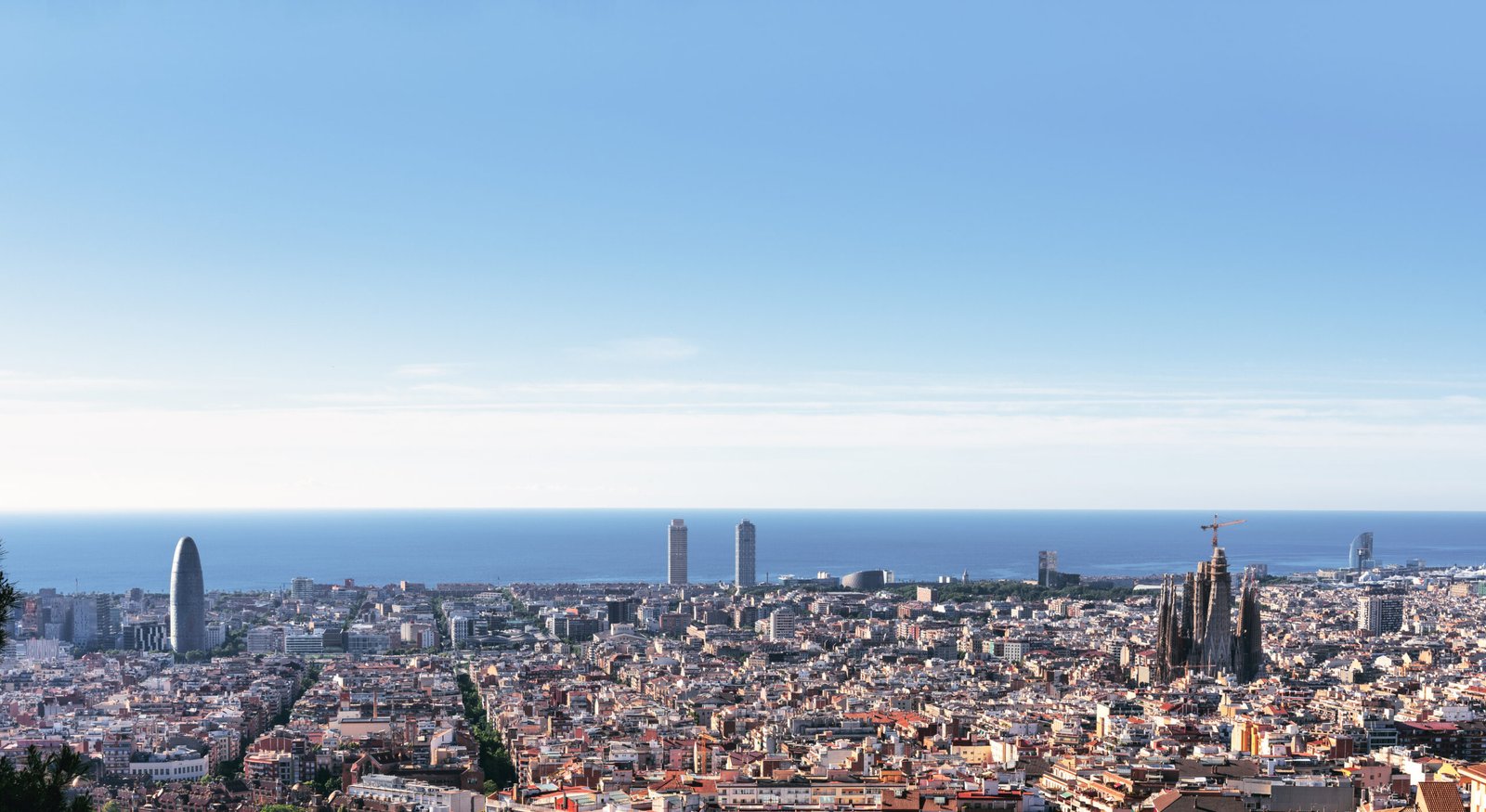 Barcelona city skyline with Mediterranean sea and blue sky