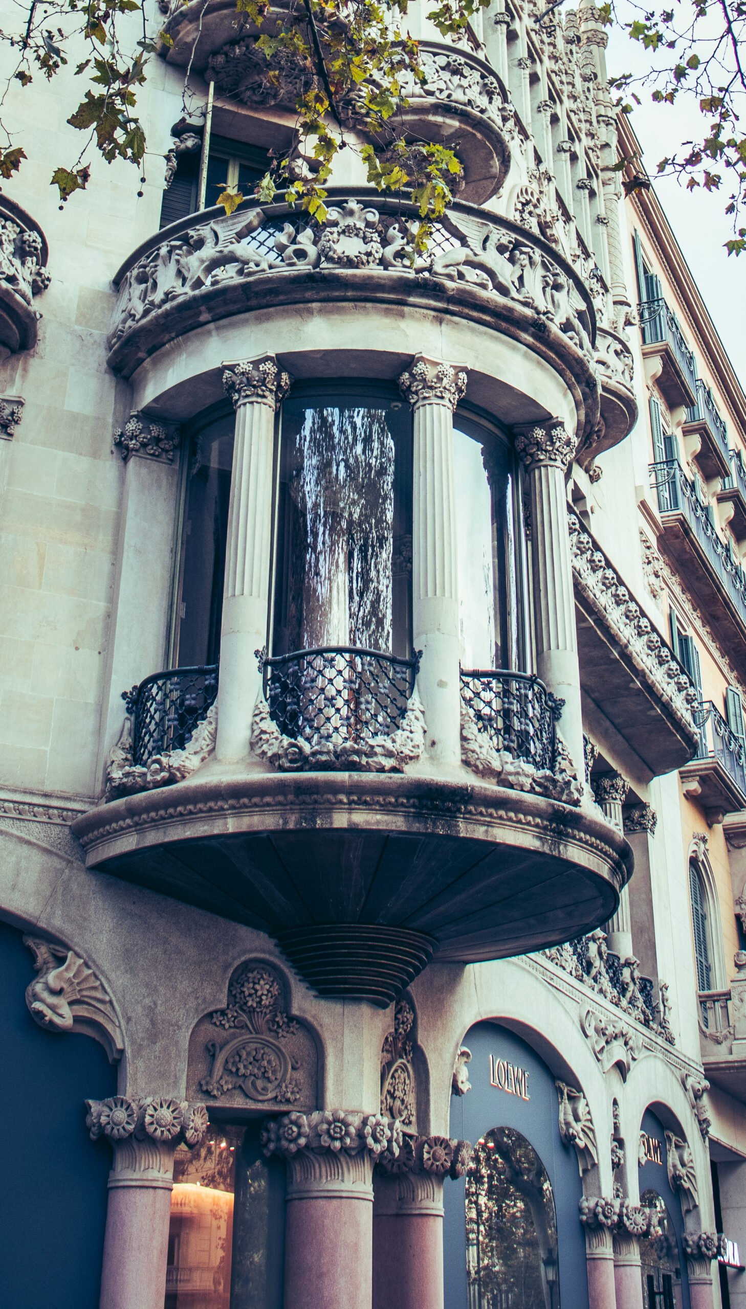 Historical apartment building with balcony on a Barcelona street at sunset