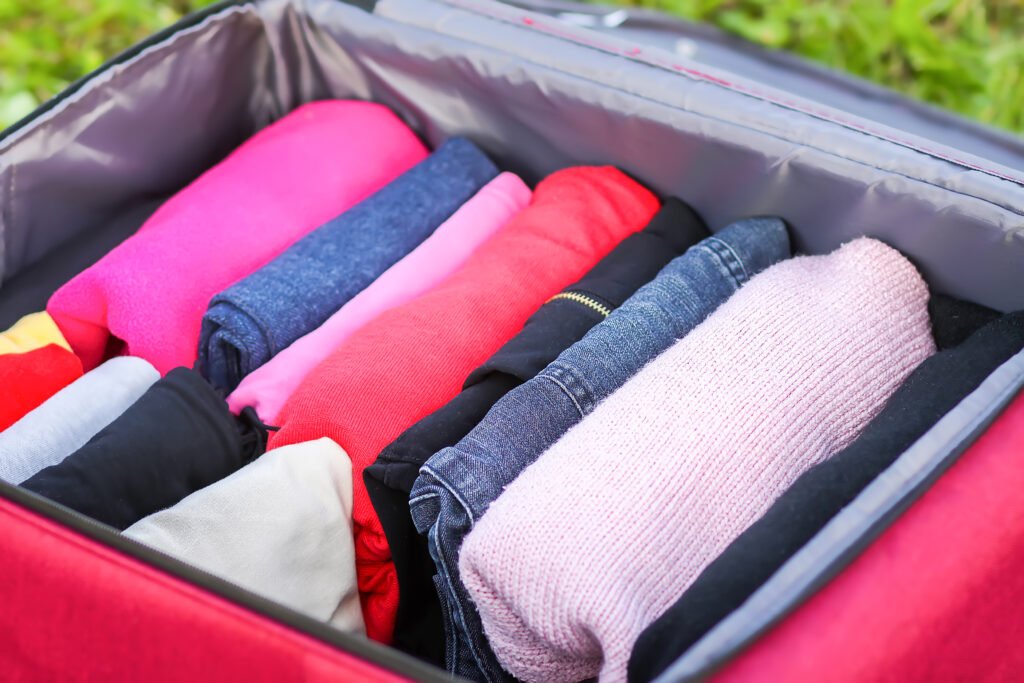 An open suitcase with clothes folded vertically for efficient carry-on packing