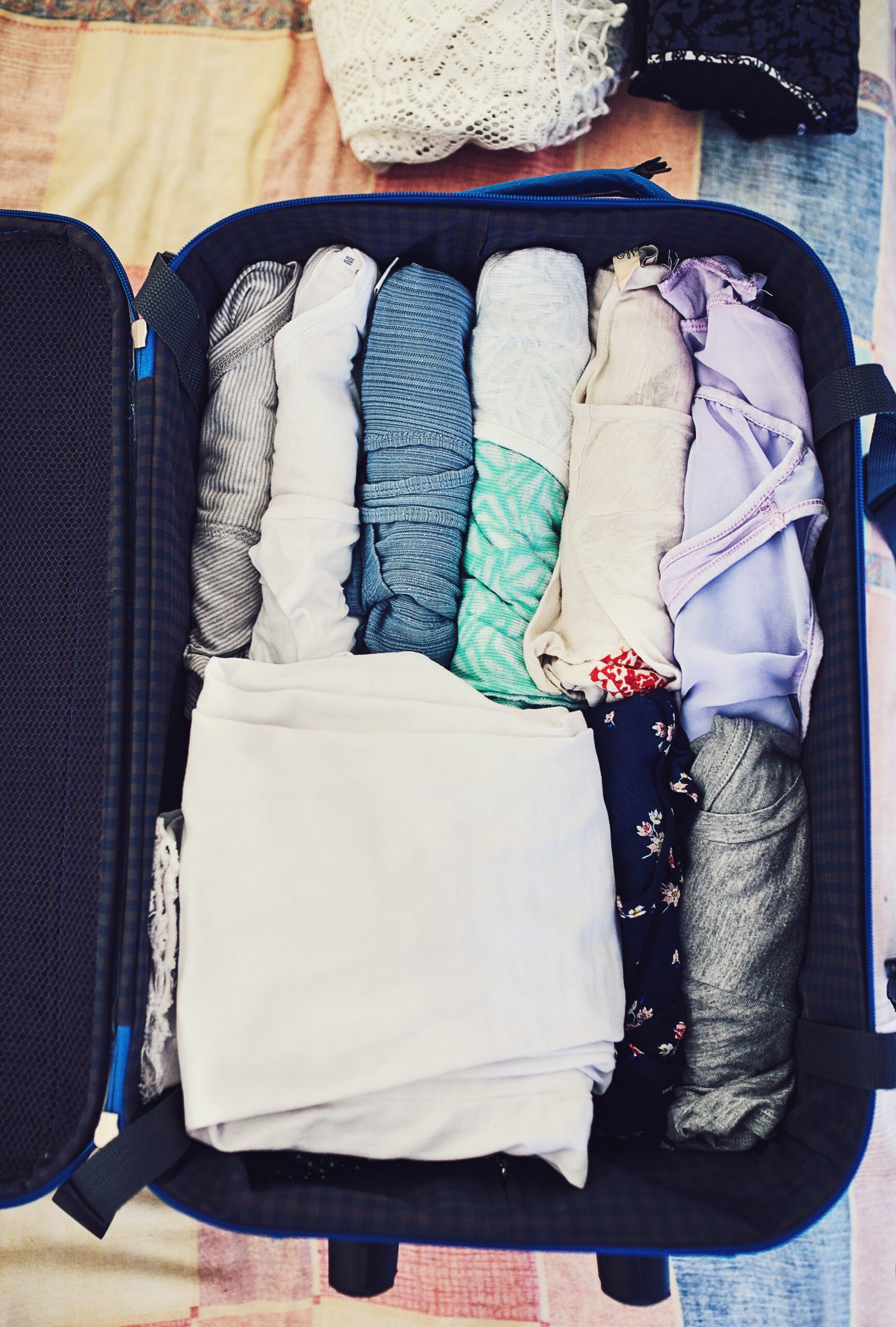 High angle shot of a suitcase packed with clothing, ready to go