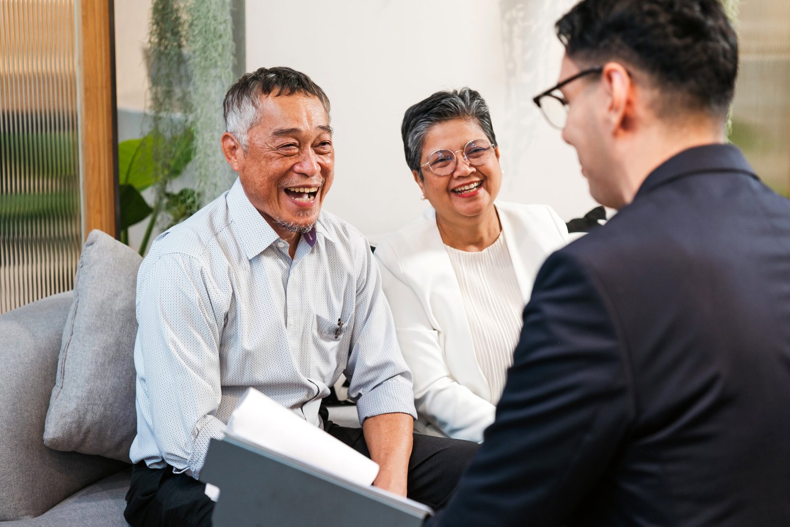 A couple meeting with a financial advisor to discuss visa and residency planning