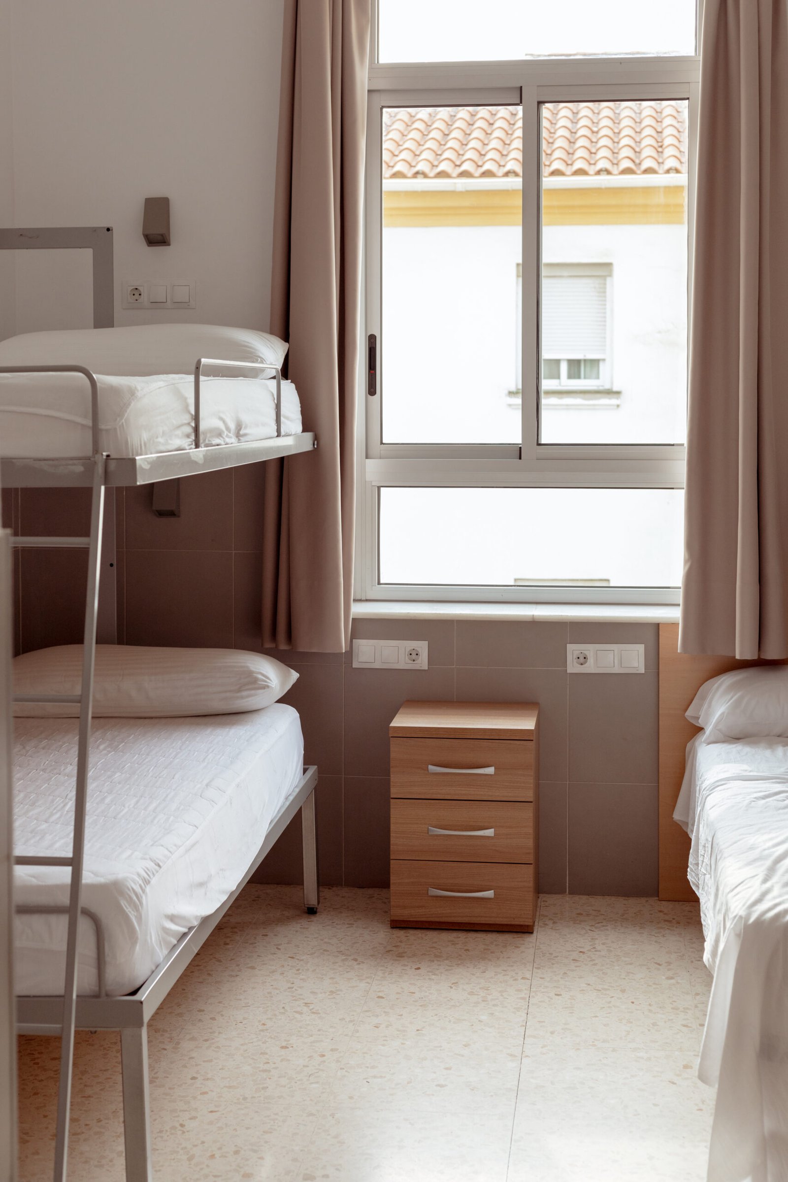 Clean minimalist hostel room with bunk bed