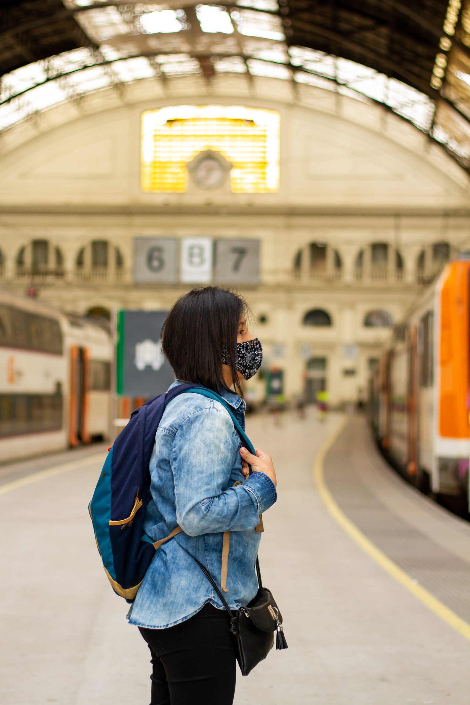 A traveler standing at a train station in Barcelona, Spain