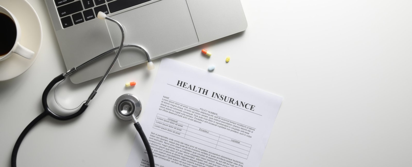Modern desk with stethoscope and health insurance documents