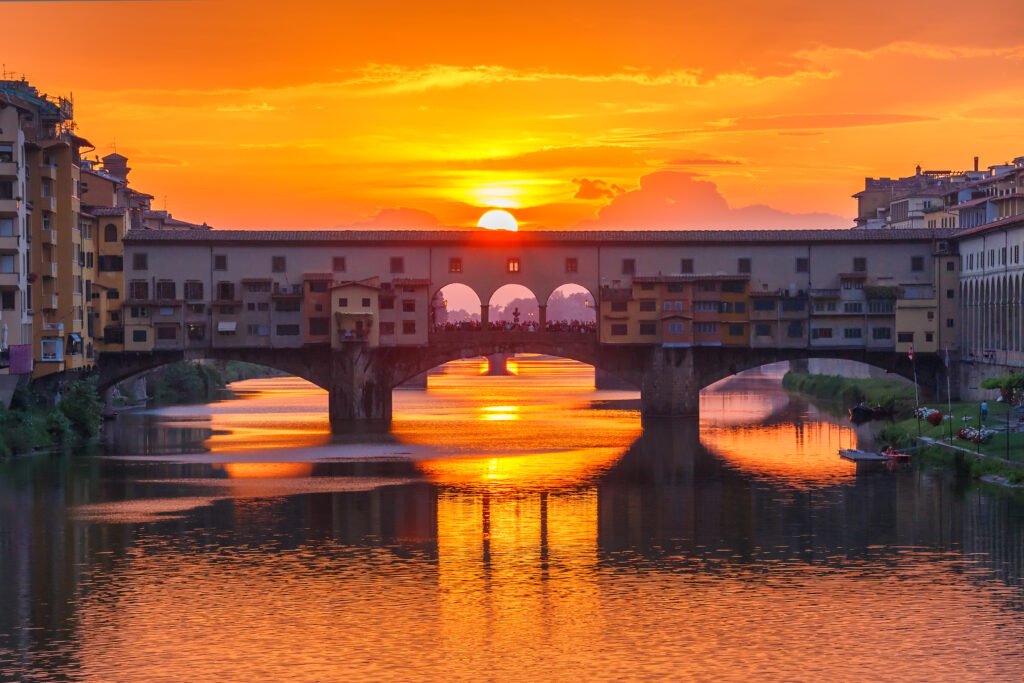 Ponte Vecchio bridge over the Arno River at sunset in Florence, Italy