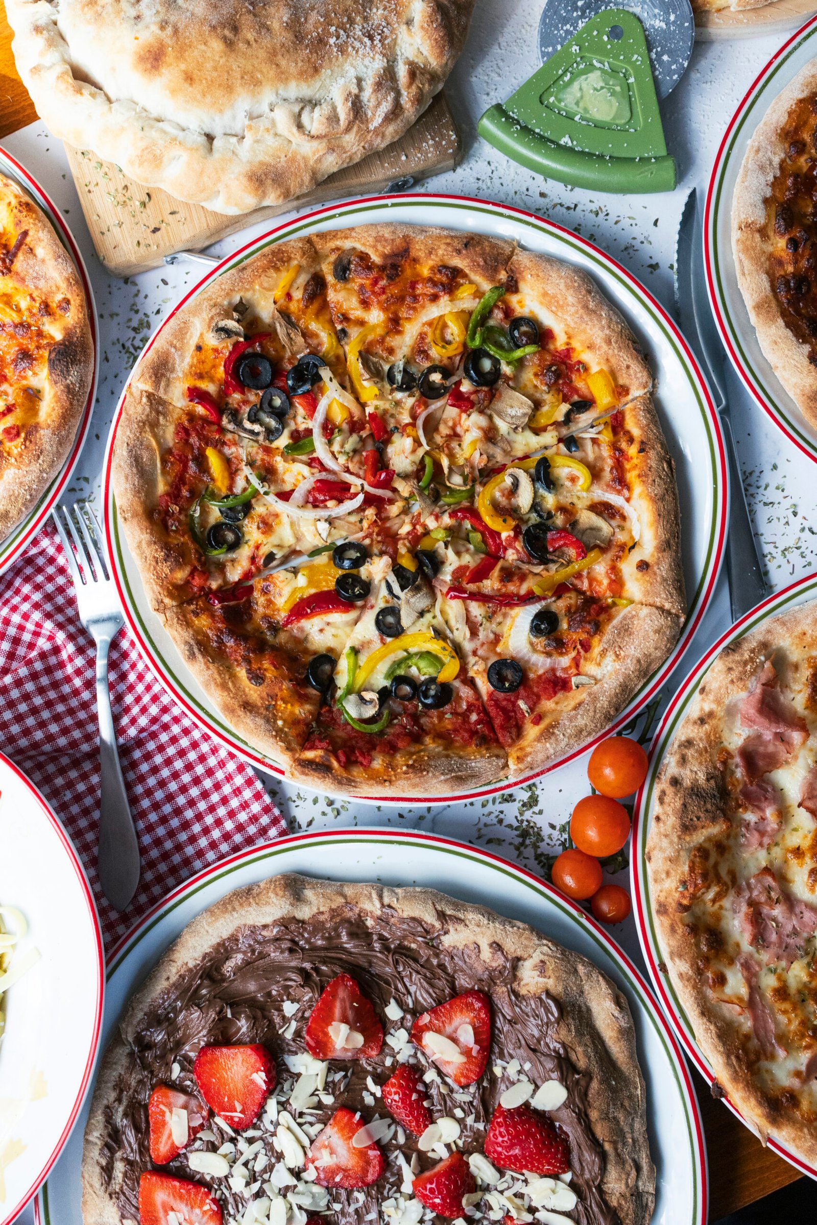 A table spread of fresh Italian pizza