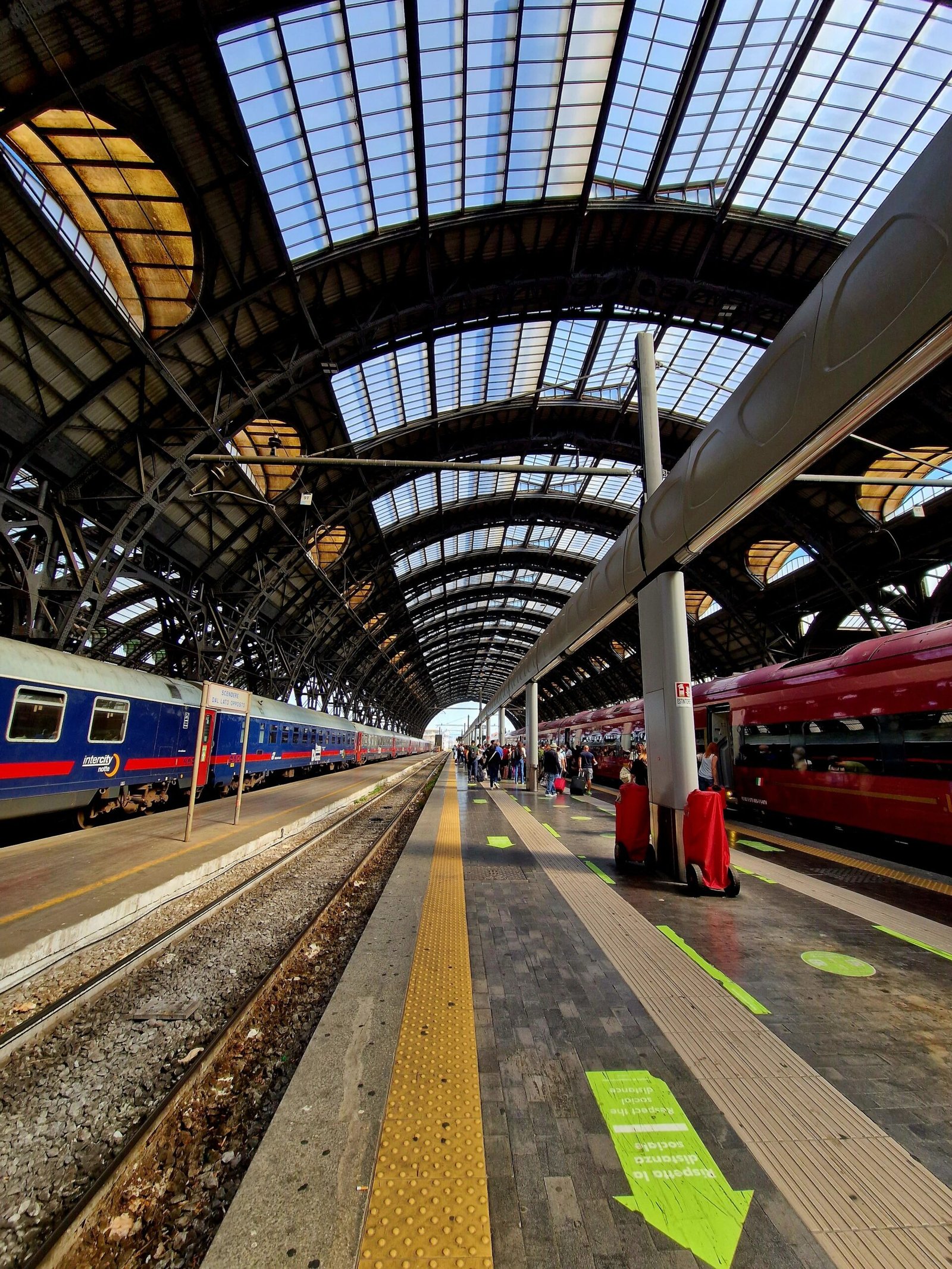 Travelers at a train station in Milan, Italy
