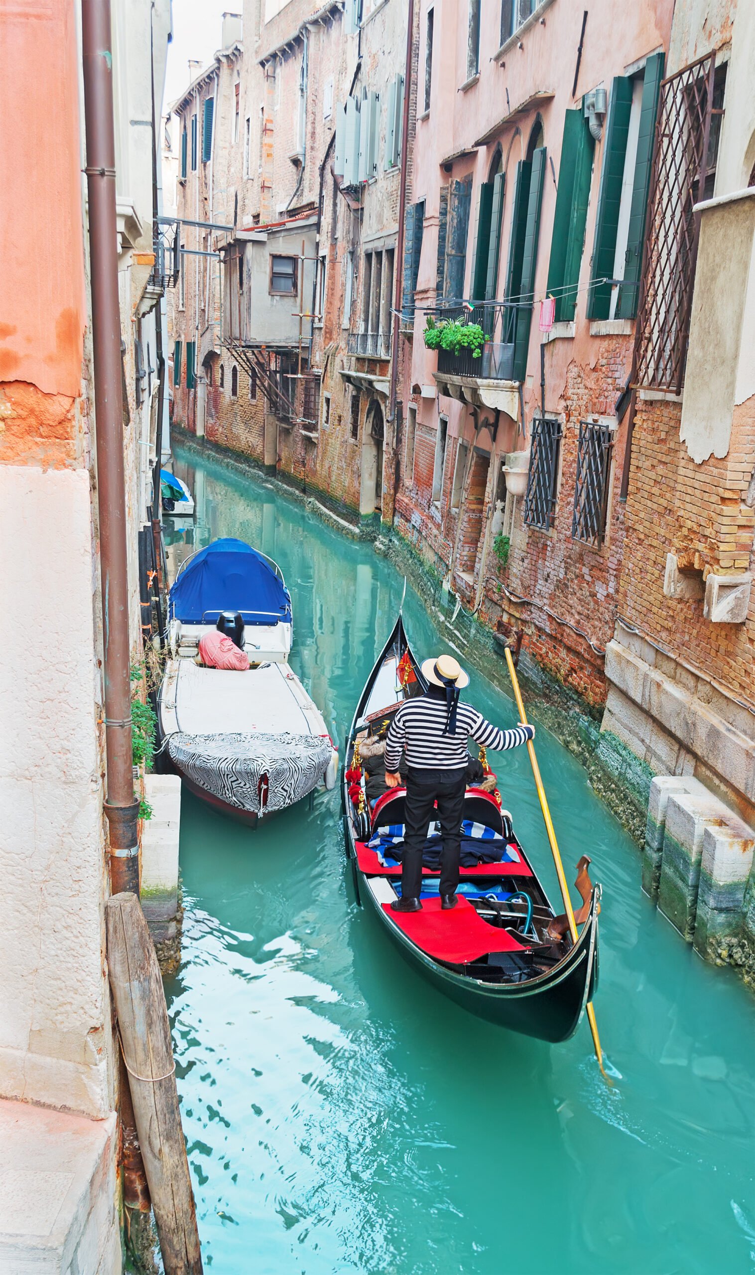 Gondola gliding through a narrow canal in Venice, Italy
