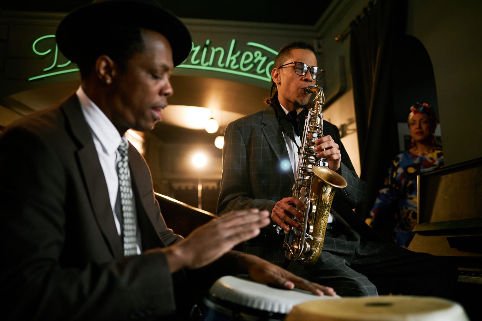 Musician playing saxophone during jazz jam session in bar