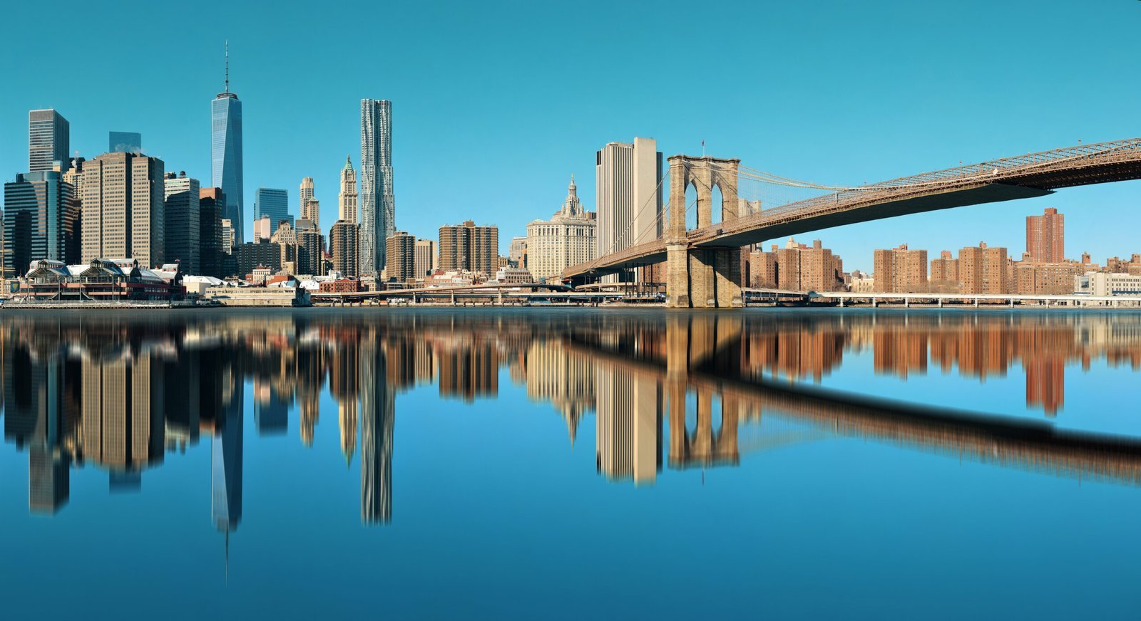Manhattan skyline with Brooklyn Bridge reflections