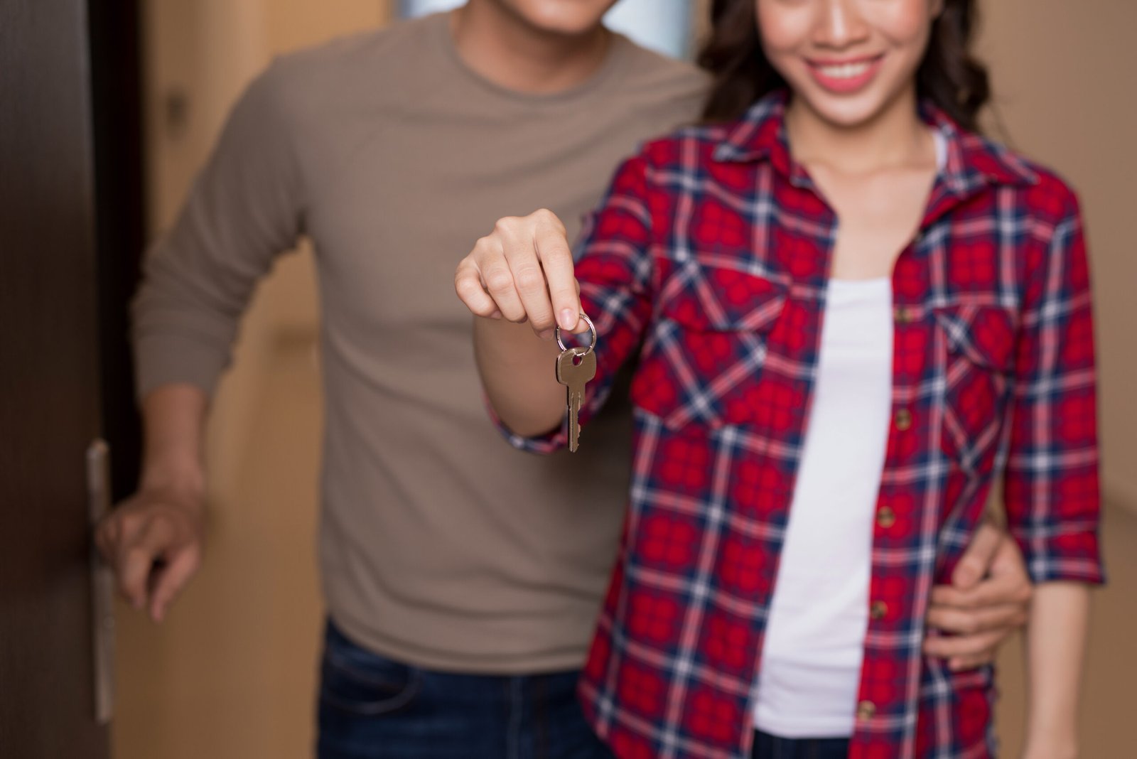 A couple receiving keys to their new apartment after moving to Spain