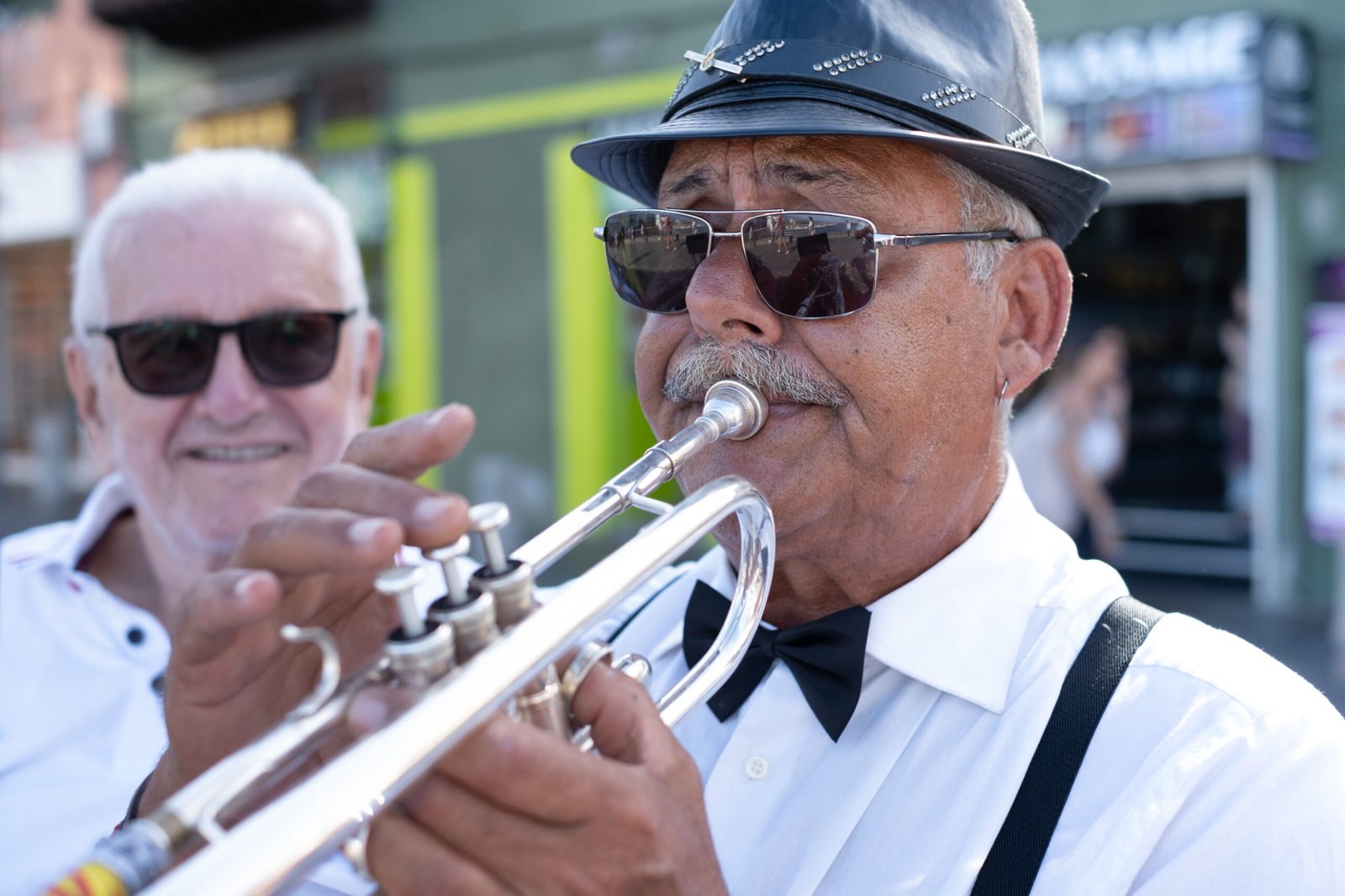 A jazz musician playing trumpet at an outdoor concert in New Orleans