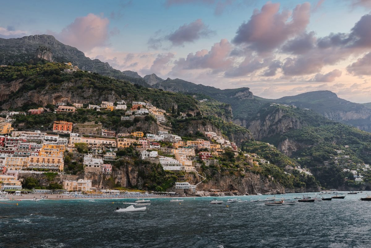 Positano's colorful hillside buildings at sunset