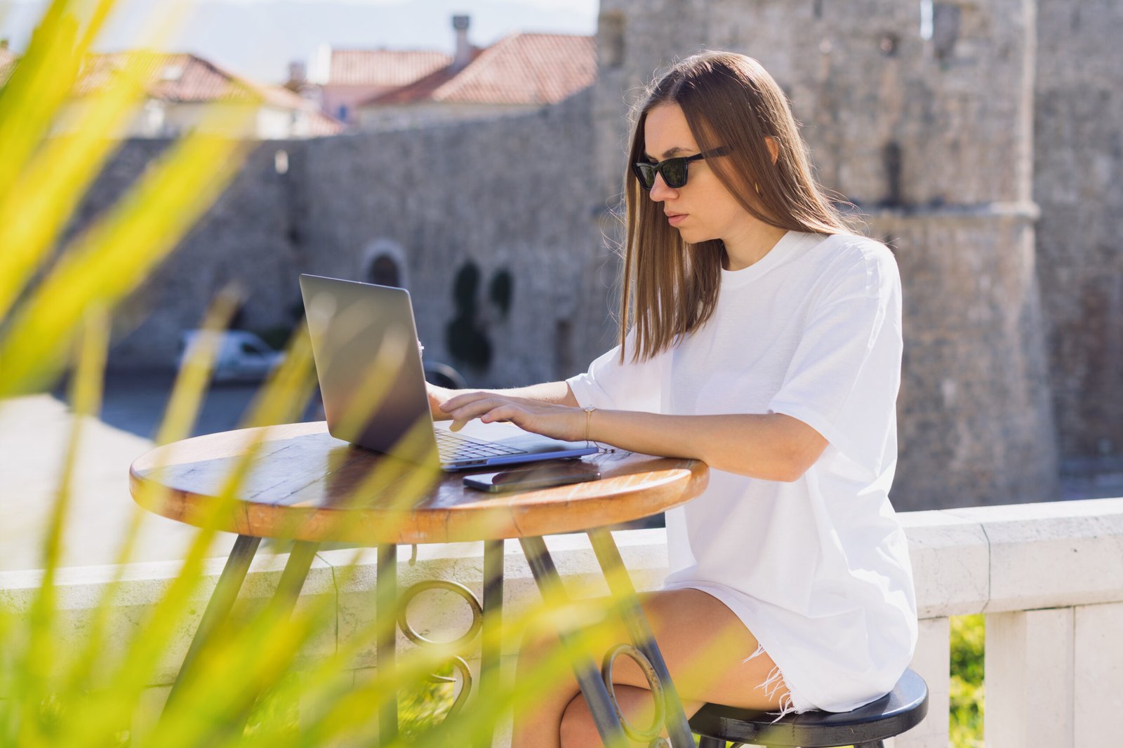 Freelancer working remotely on a laptop at a European cafe