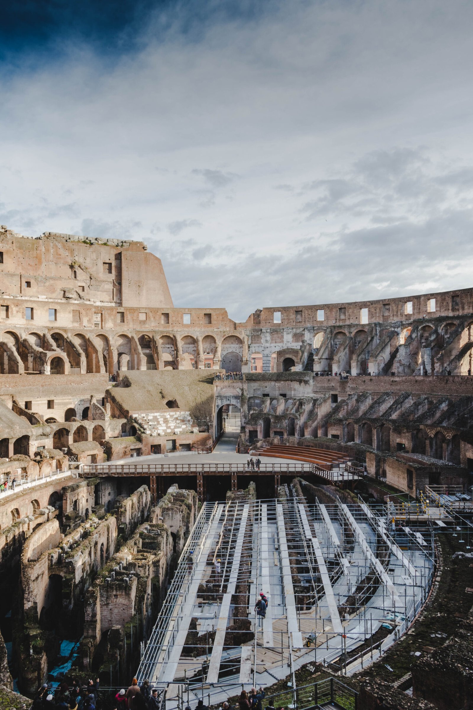 Vertical shot of the Colosseum under a cloudy sky in Rome, Italy