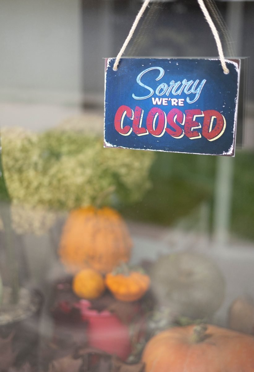 A closed office sign, a reminder of limited hours