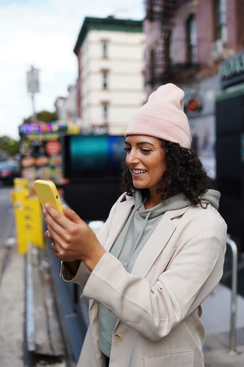 A solo traveler exploring a city with her phone