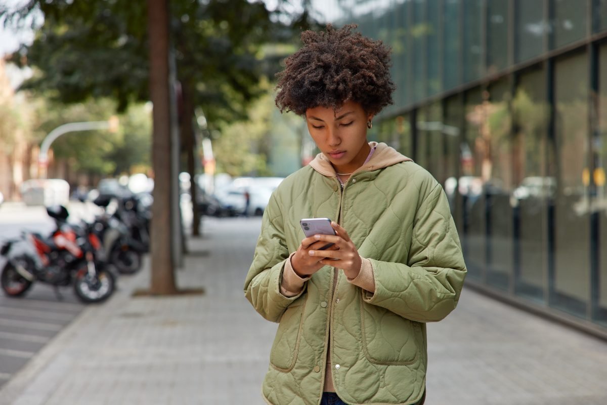 A solo traveler setting up apps on her phone
