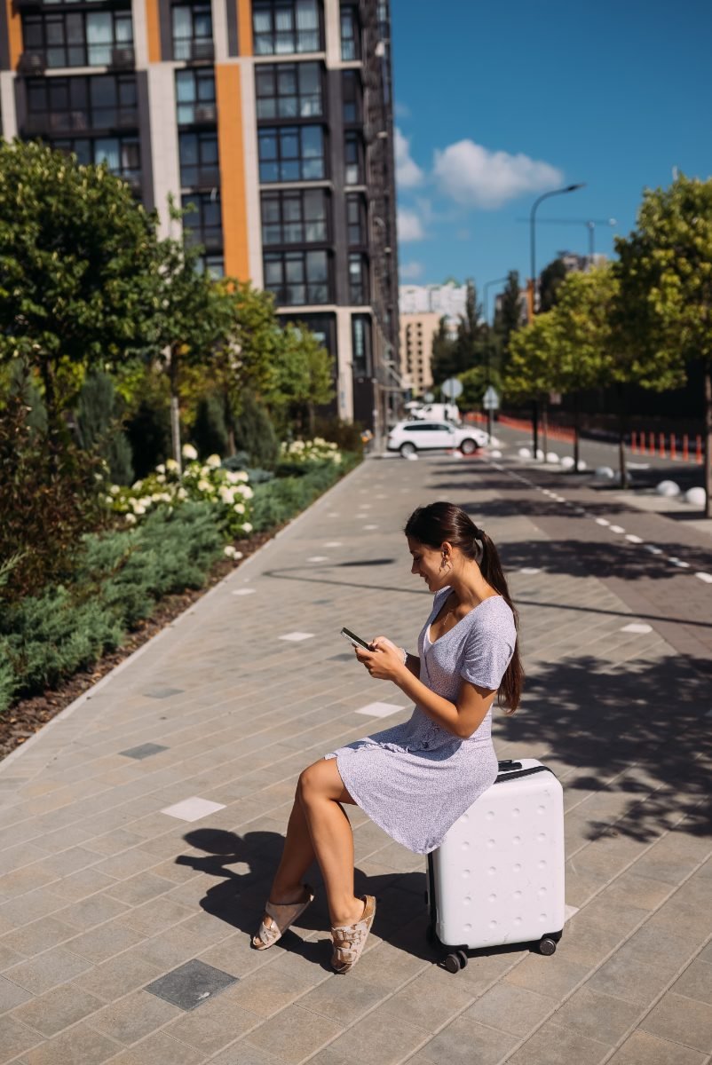 A solo traveler booking on her phone