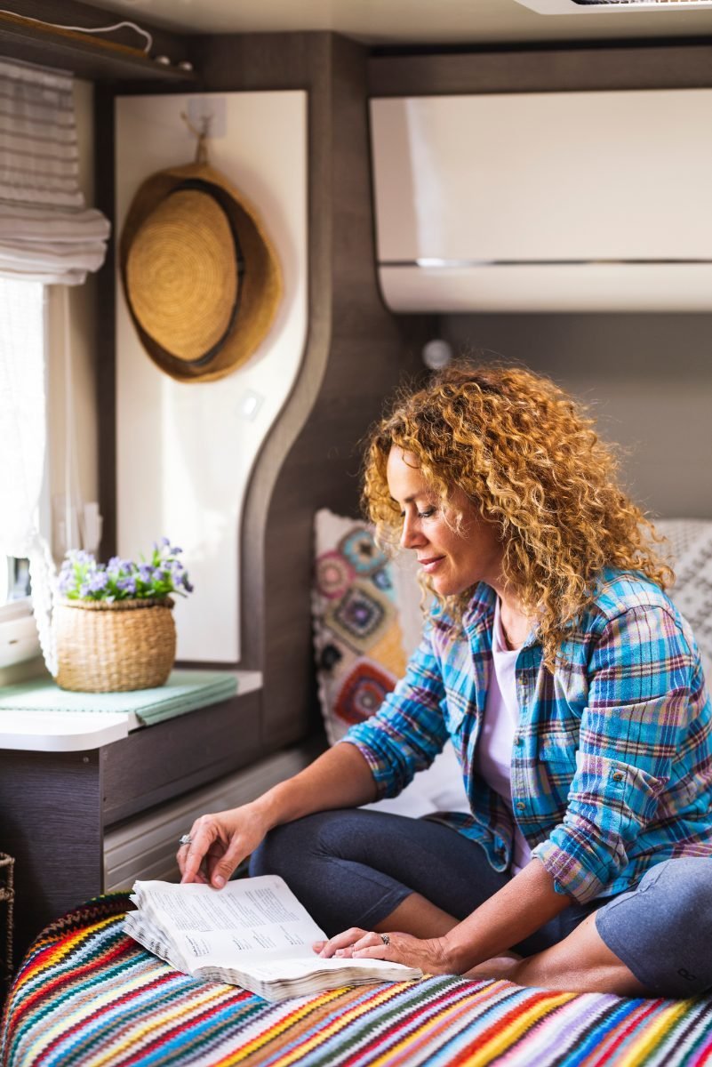 A solo traveler relaxing in a budget camper van