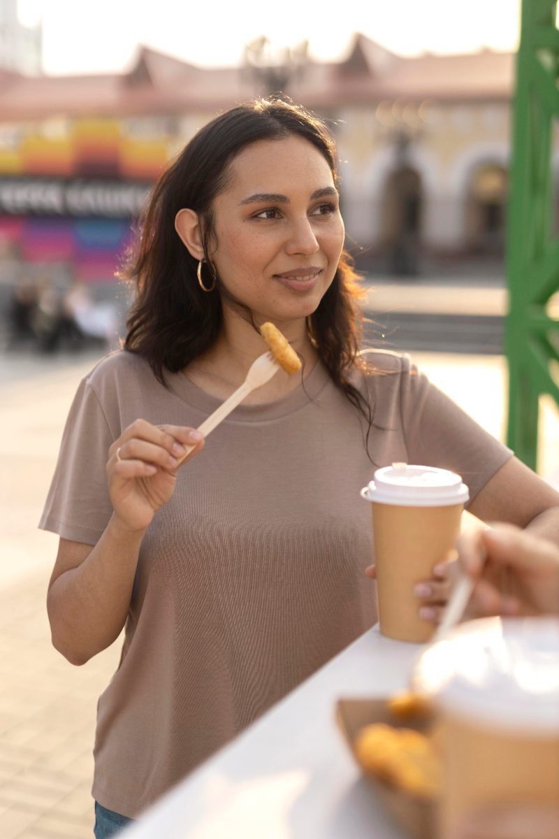 A solo traveler eating cheap street food