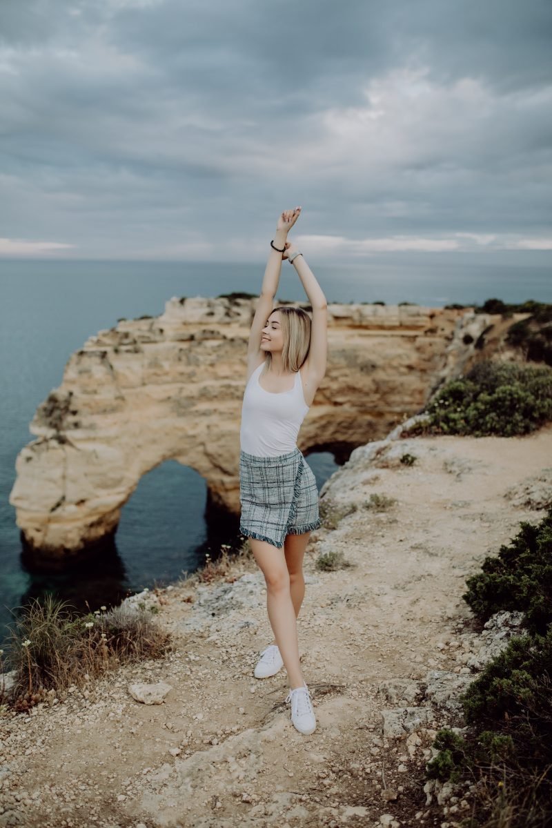 A solo traveler with arms wide open, feeling free