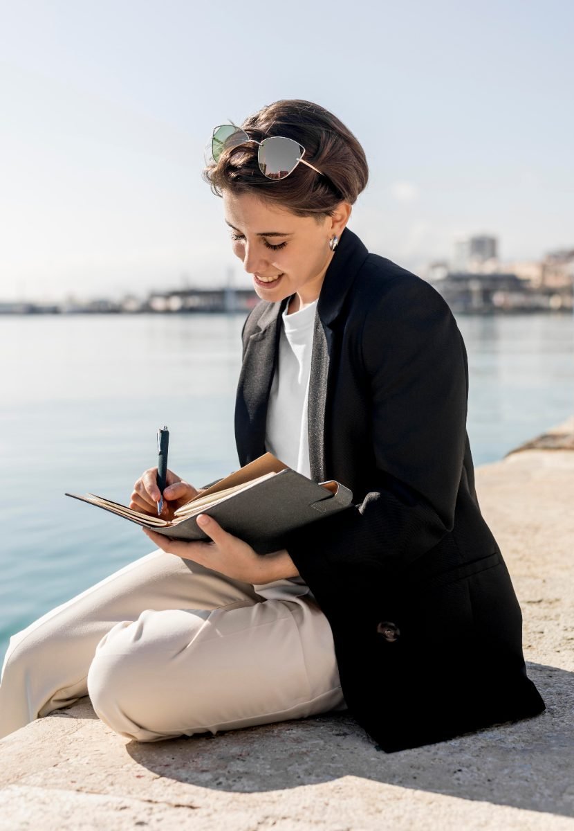 A solo traveler journaling and planning her trip