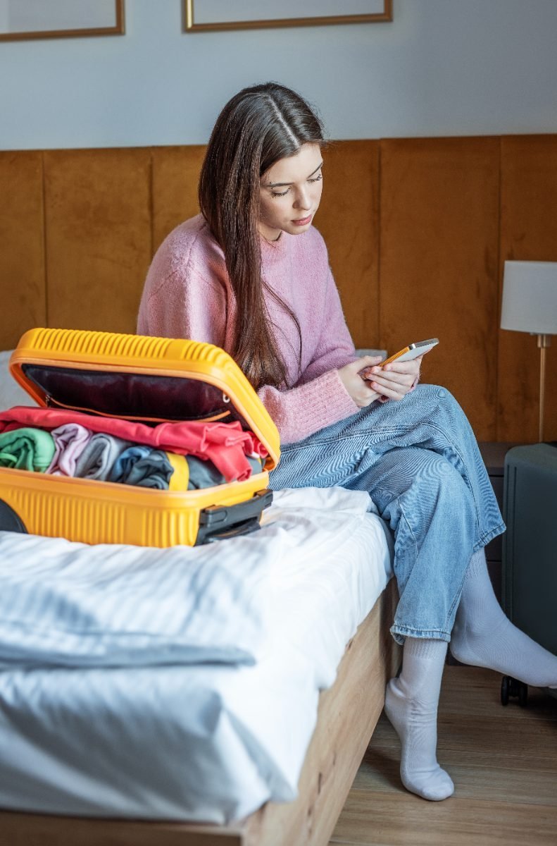 A solo traveler ready to go with packed luggage