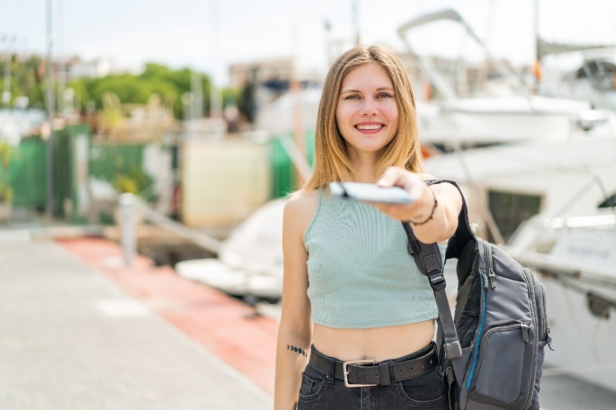 A solo traveler holding her passport