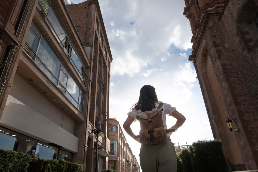 Solo woman traveler walking in a cityscape at sunset