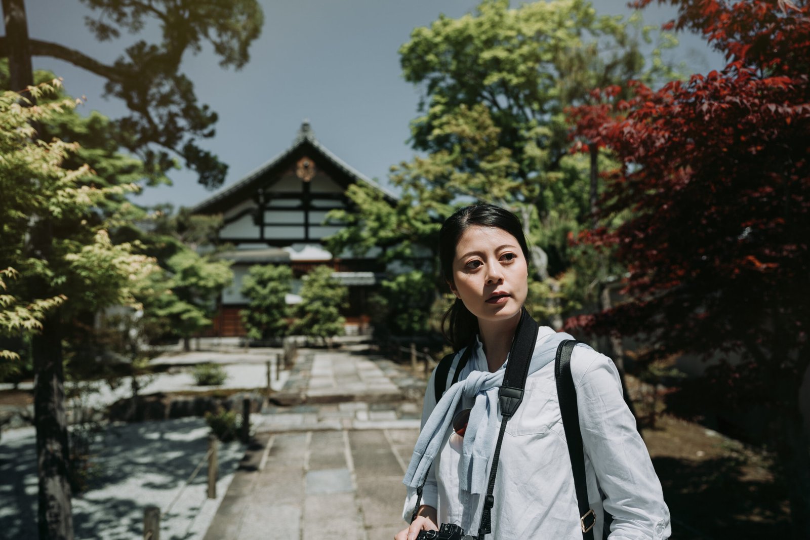 Solo traveler walking stone path at Kyoto Japan temple