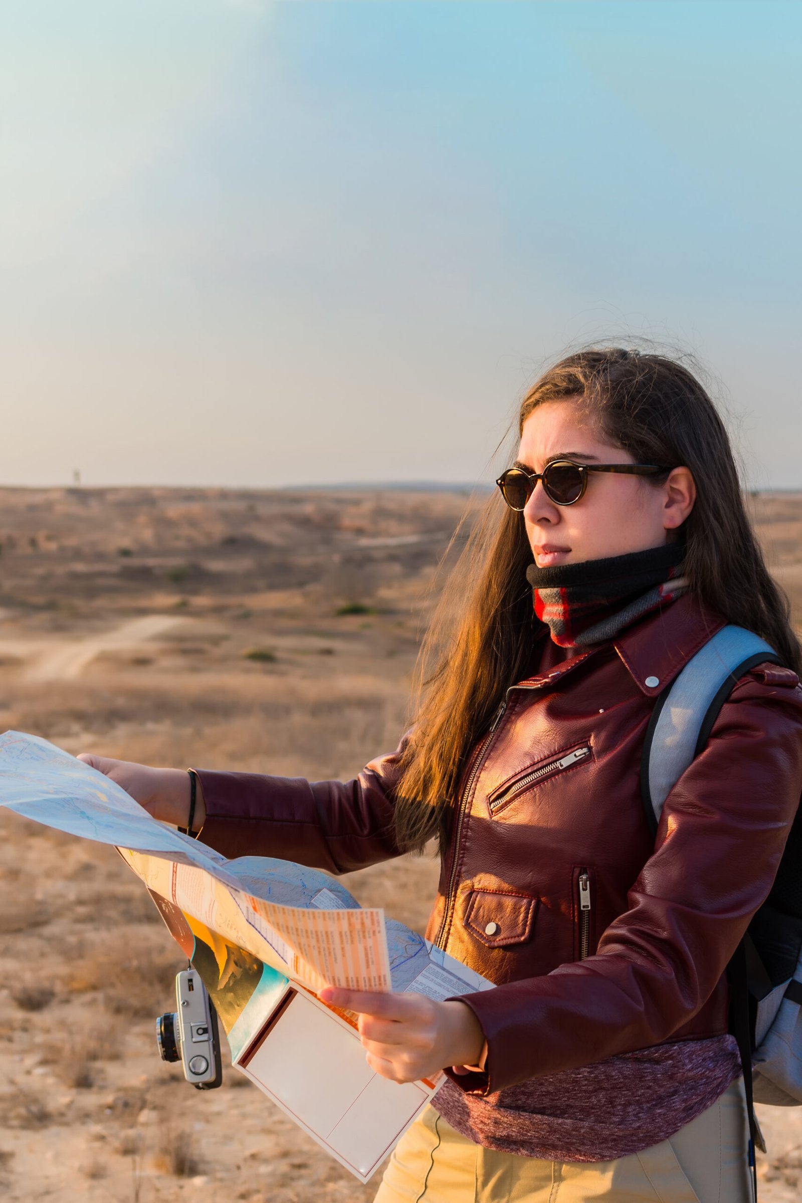 A solo female traveler consulting a travel map