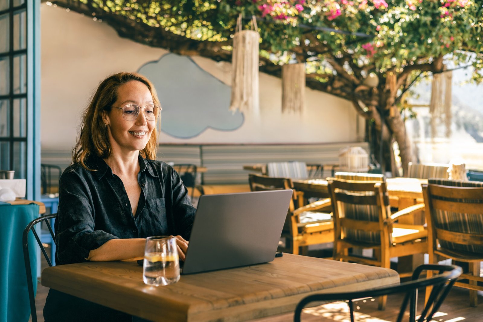 Remote worker on a laptop at an outdoor cafe, digital nomad lifestyle in Spain
