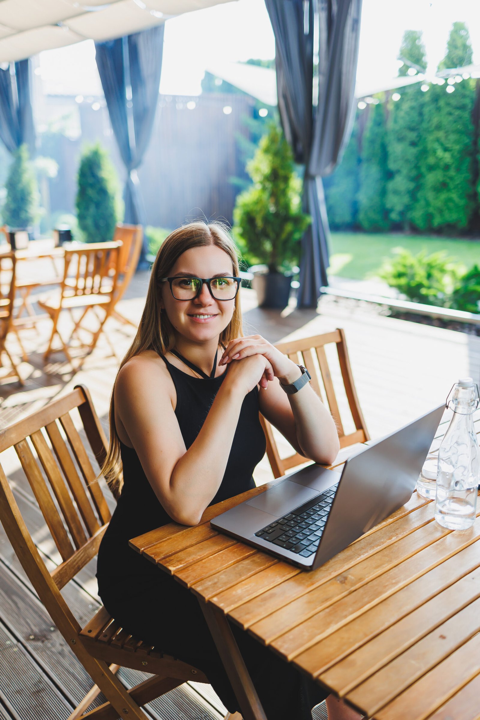 Freelancer working on a laptop at a summer terrace cafe in Spain