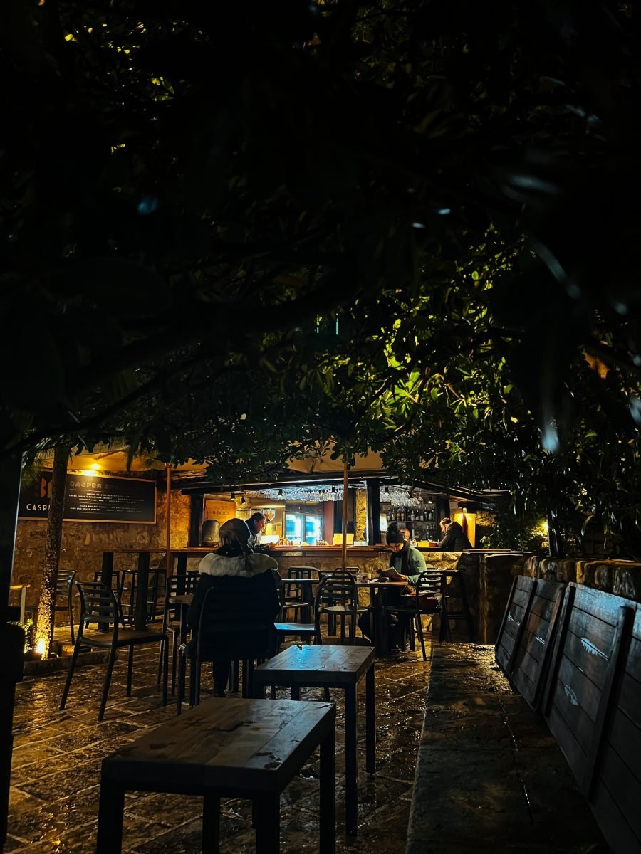 People at a street cafe at night