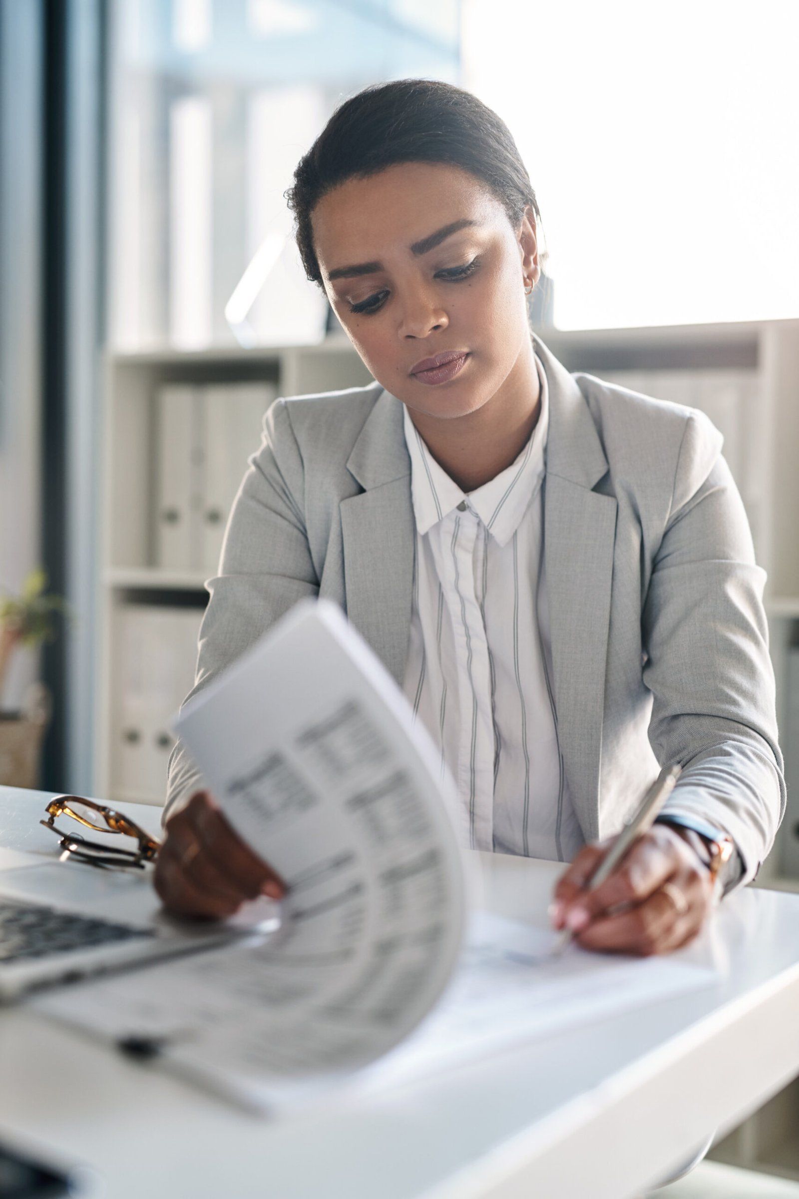 Woman reviewing and signing paperwork for a bank account and residency documents