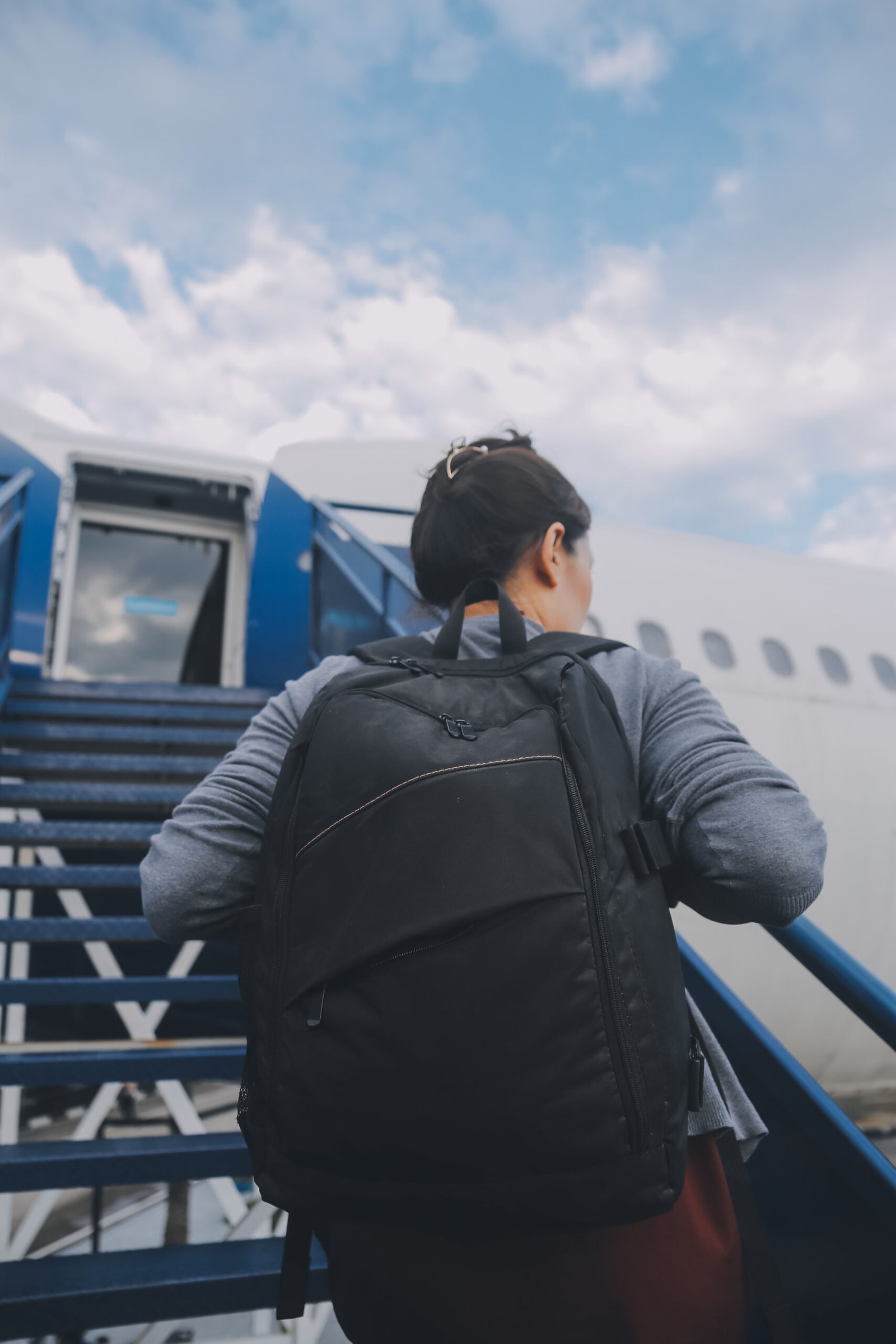 A traveler with a backpack at a modern airport terminal