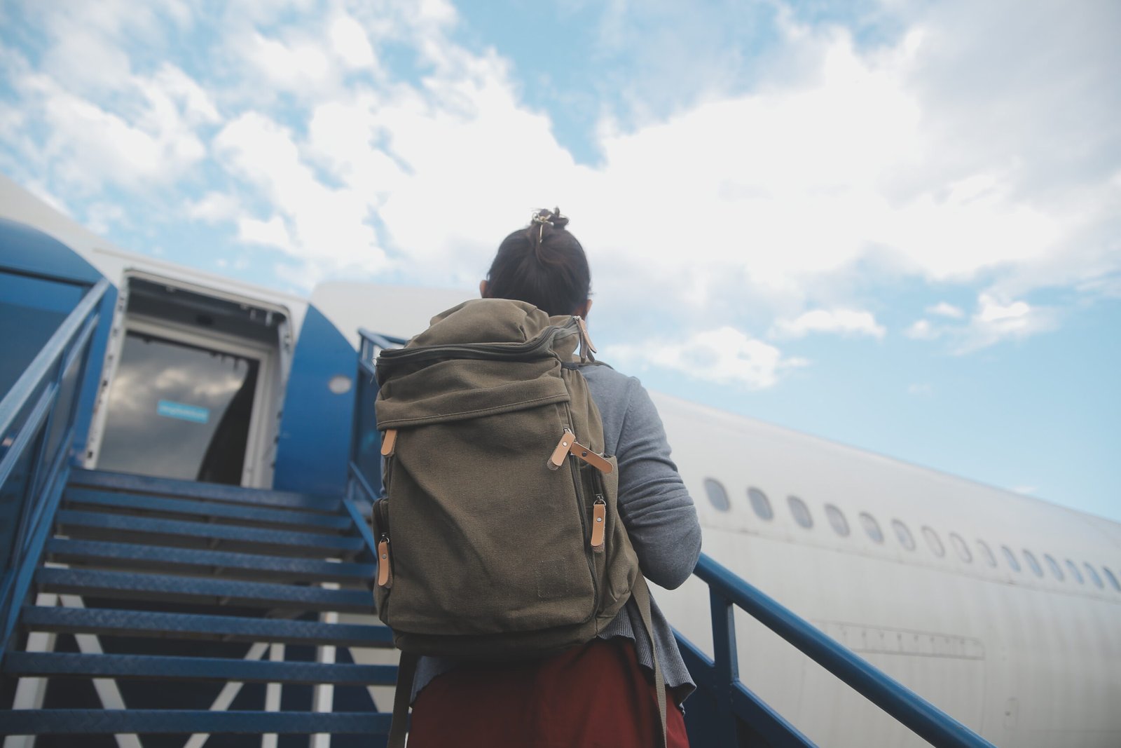 A traveler with a backpack at a modern airport terminal