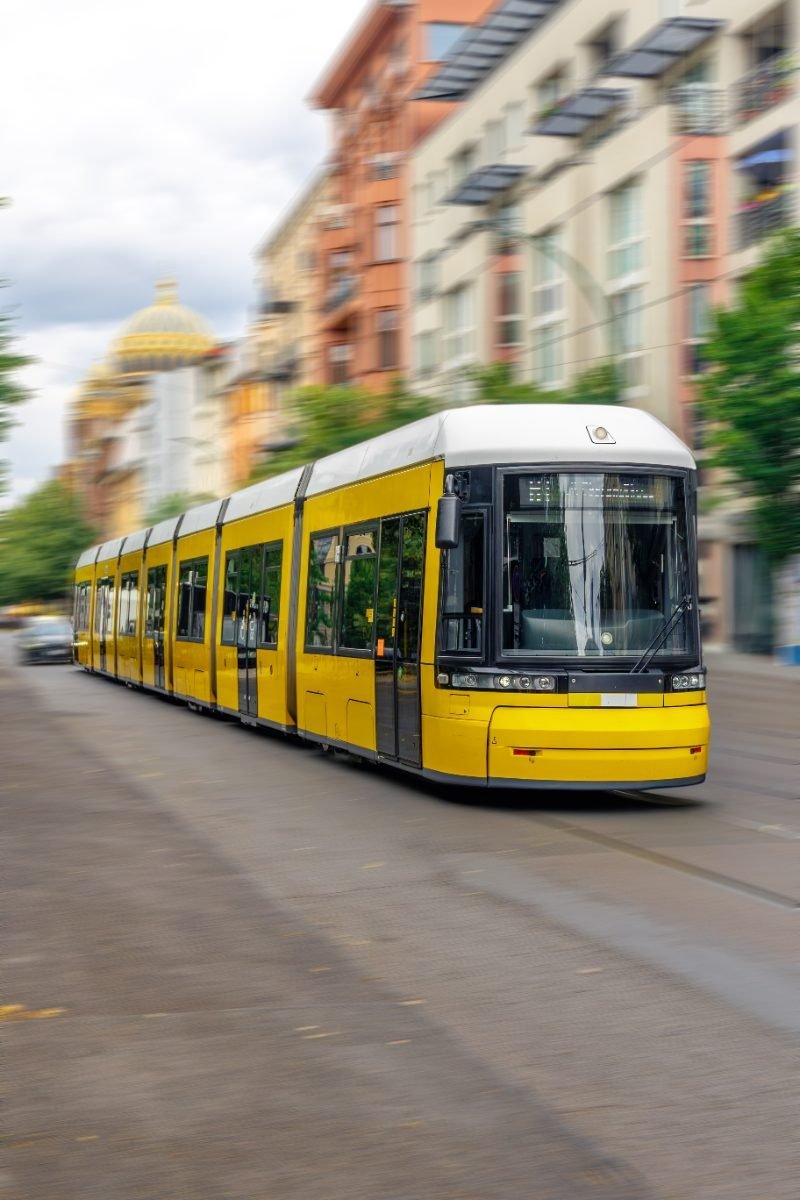 Yellow tram moving through the city