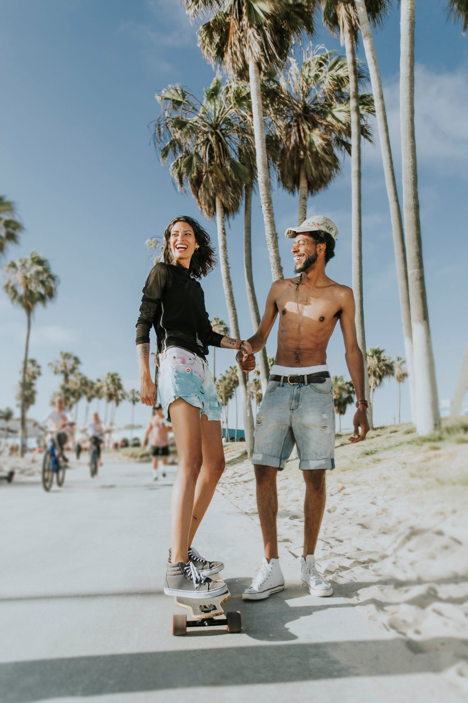 Couple longboarding at Venice Beach Los Angeles