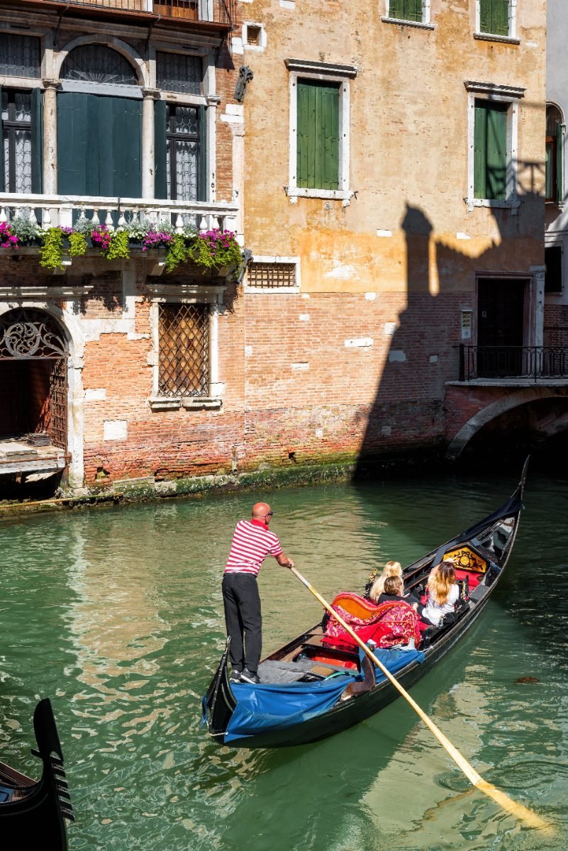 Gondola floating along a narrow Venice canal
