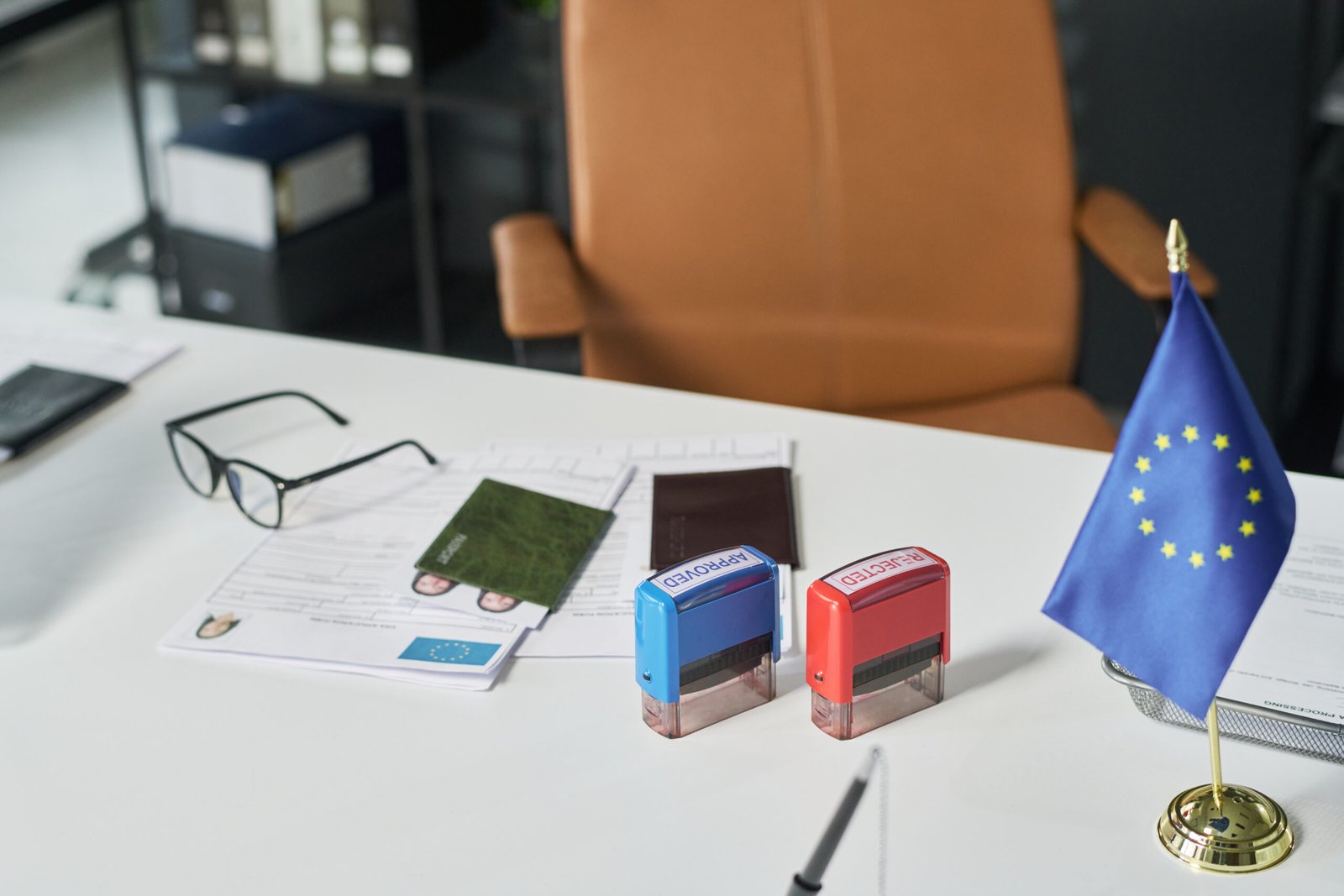 Visa application documents and passport processing at desk