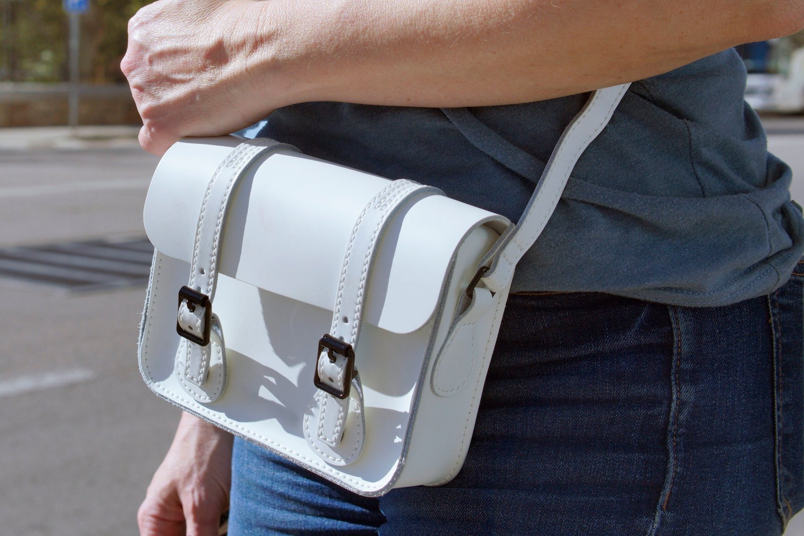 Woman carrying secure crossbody bag while walking in city