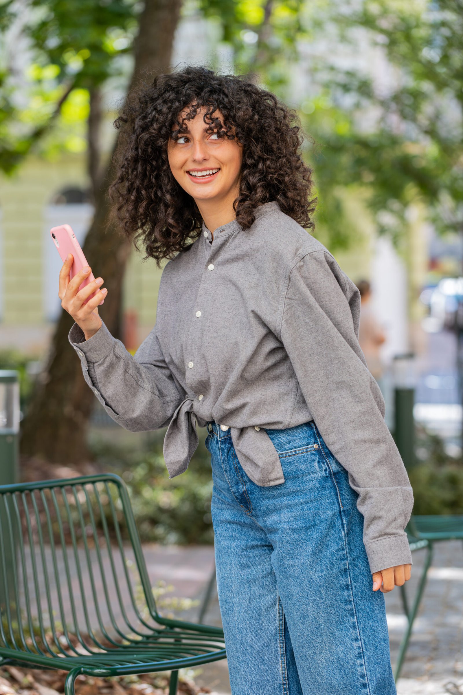Woman using smartphone map on city street