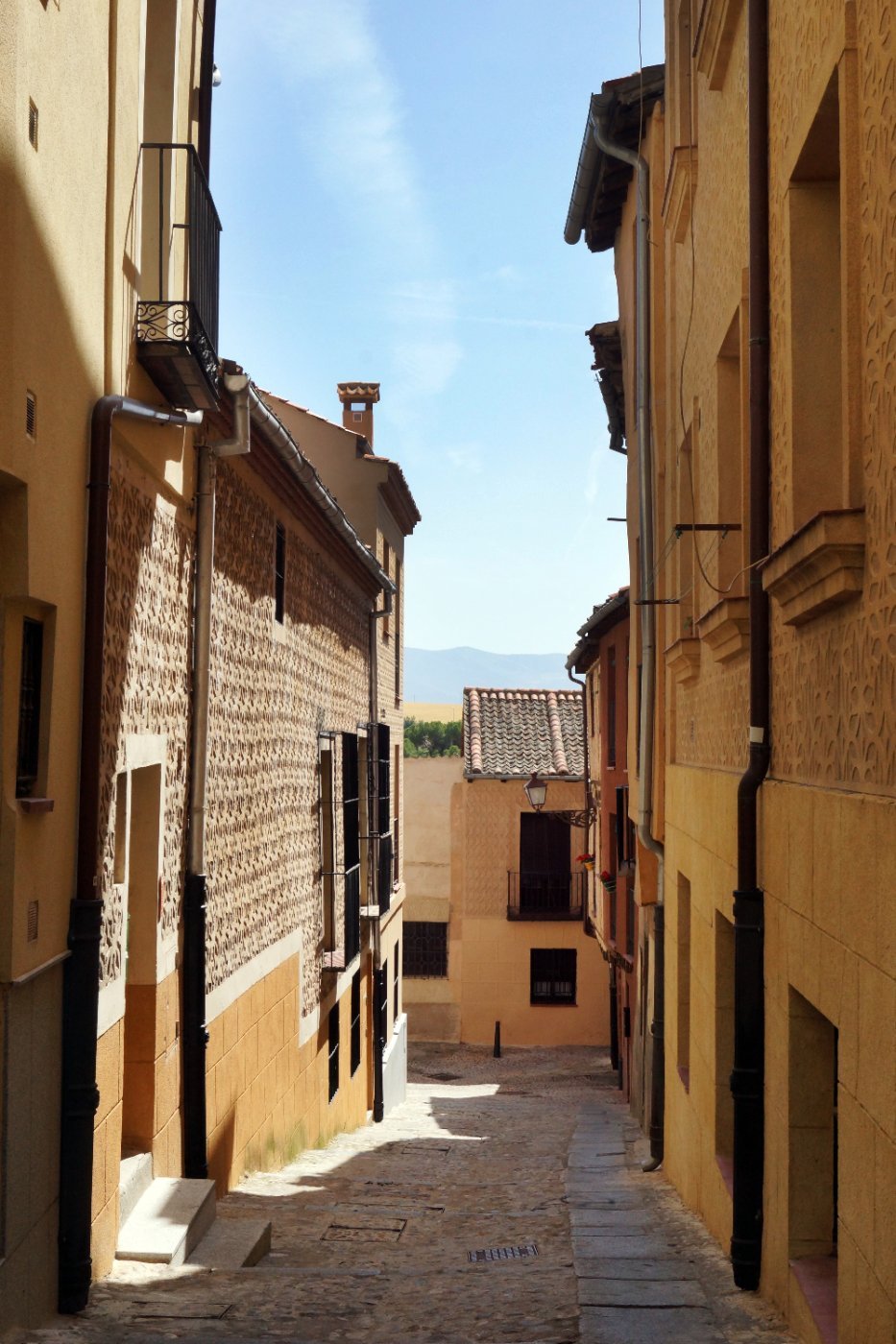 A narrow stone street in the old town of Segovia, Spain