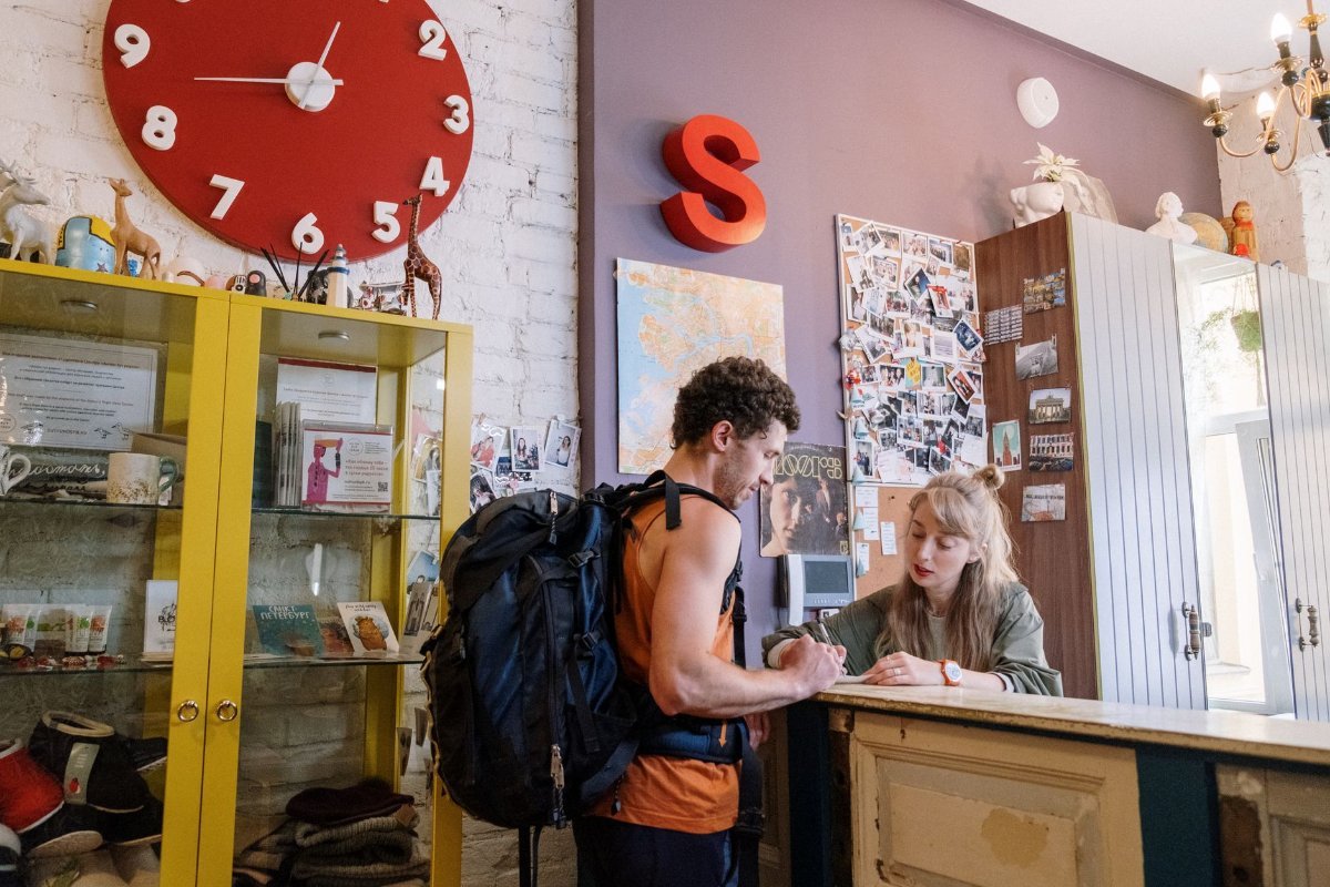 A backpack and luggage at a hostel check-in